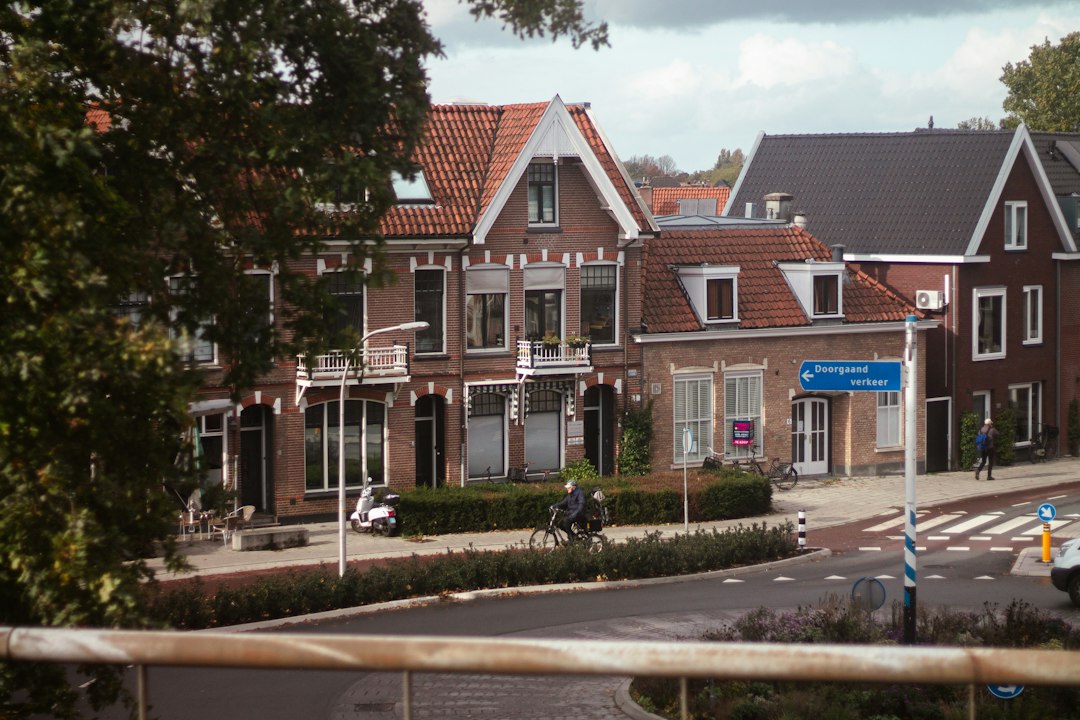 Street view with brick houses and people cycling